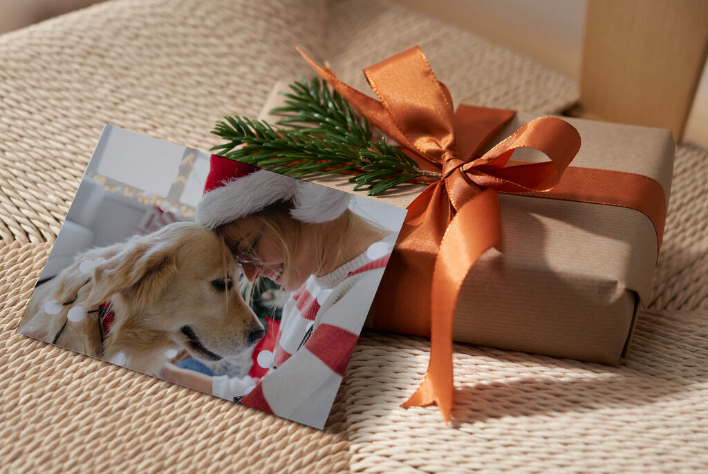 A lovingly wrapped gift with an orange ribbon and a photo of an animal on the attached card