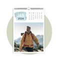 Man with sunglasses and yellow jacket hiking in the mountains.